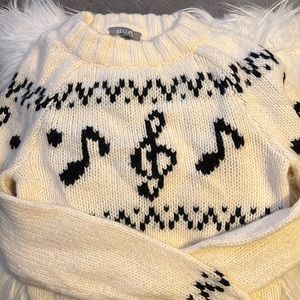 Cream sweater with musical notes